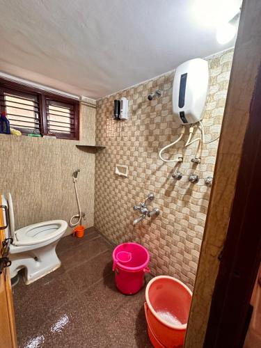 a bathroom with a toilet and a shower at Sri Devi Krupa in Hubli