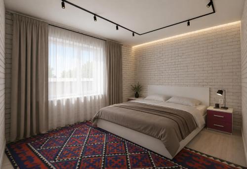 a bedroom with a large bed and a brick wall at Guest house B&B in Kochkorka