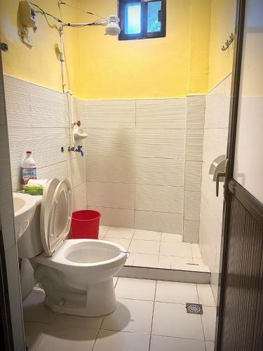 a bathroom with a toilet and a sink at 2 Bedrooms with free parking in Baguio