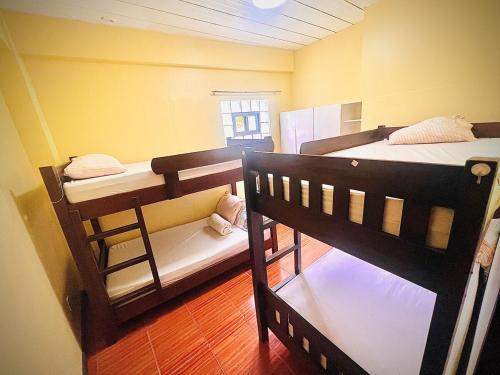 a room with three bunk beds in a room at 2 Bedrooms with free parking in Baguio