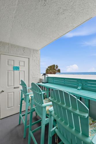 a balcony with chairs and a view of the ocean at Beachfront Bliss 3BR Oceanfront Condo with Pool and Hot Tub in Myrtle Beach