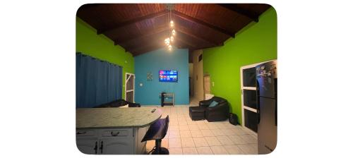 a room with green walls and a kitchen with a counter at Ocean veiw Apartment in Telescope