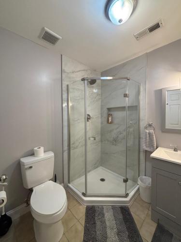 a bathroom with a shower and a toilet and a sink at Riverside Retreat in Camden