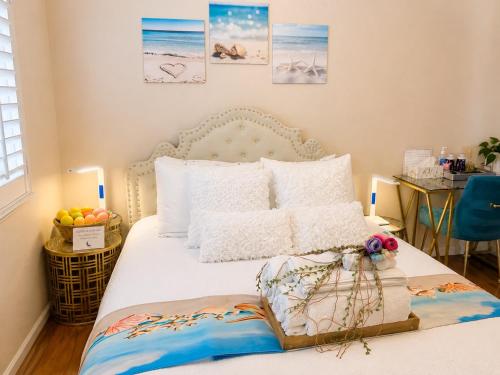 a bed with white sheets and pillows in a bedroom at Balloons and Wine in Murrieta