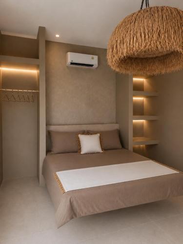 a bedroom with a bed and a air conditioner at La Caza Sowana in Ko Phangan