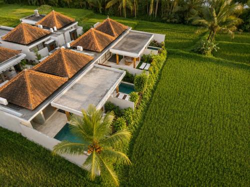 an aerial view of a house with a swimming pool at Arta Private Villa in Ubud
