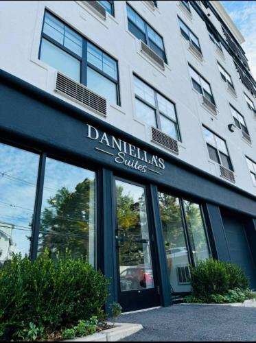 a building with a sign on the front of it at Daniella's Suites in Peabody