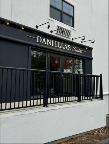 a store with a black fence in front of a building at Daniella's Suites in Peabody