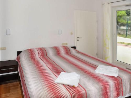a bedroom with a bed with two towels on it at Apartments Despot Zaostrog RC in Zaostrog