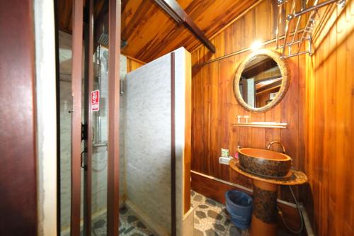a bathroom with a sink and a mirror at KhounPhet Hotel in Luang Prabang