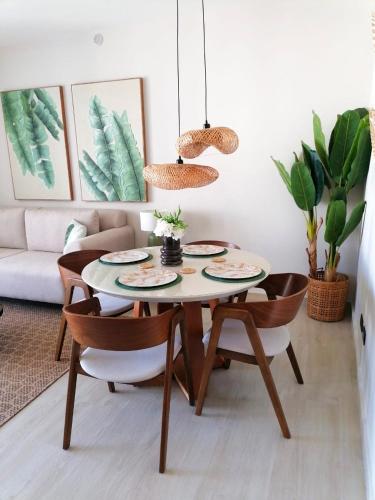 a dining room table and chairs in a living room at Green Oasis - Dominicus, Bayahibe in La Laguna