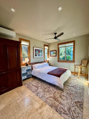 a bedroom with a large bed and a ceiling fan at Hilltop View Sanctuary in Fallbrook