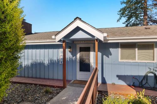 a house with a porch and a white door at Phenomenal Sunsets Wild Orca & Private Beach in Shelton