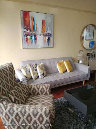 a living room with a couch and a table at The Mosaic Tower in Manila