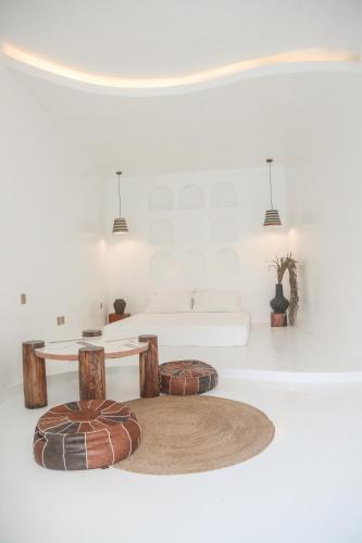 a white room with a table and two stools at bassa resort in Panglao Island