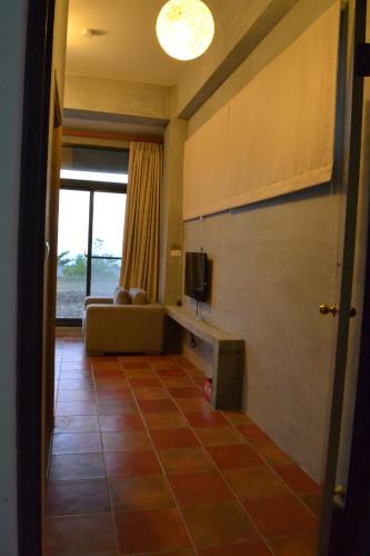 a living room with a couch and a television at David SamStrong Villa 大尾山姆維拉 in Chenggong