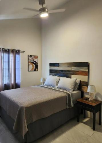 a bedroom with a large bed and a table at Deluxe Estate in Portmore