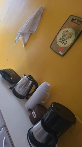 a counter top with a group of kitchen utensils at Joy Apartamento completo in Salvador