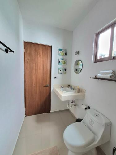 a bathroom with a toilet and a sink at Casa Terracota Micro Hotel Consulado in Mérida
