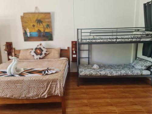 a room with two bunk beds and a couch at Maya Resort Samui - Family Resort in Bophut