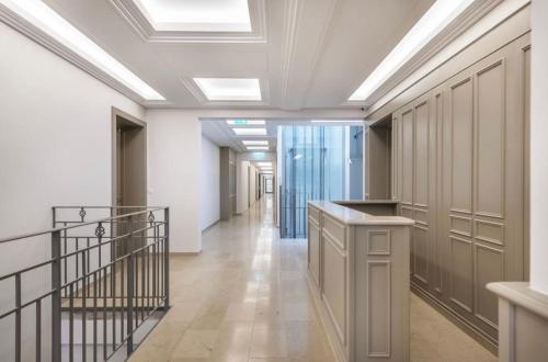 a corridor in a building with a hallway with a staircase at Vilnius Apartments & Suites – Old Town in Vilnius