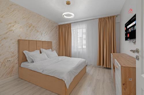 a bedroom with a bed and a television in it at Vibe Luxury Studio - Militari Residence - Parcare Privata Gratuita in Chiajna