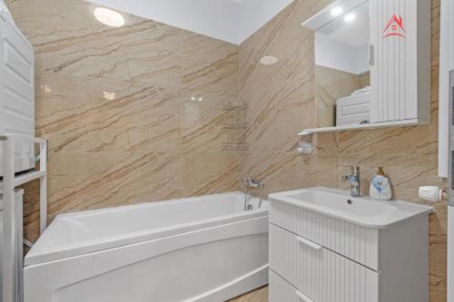 a white bathroom with a tub and a sink at Vibe Luxury Studio - Militari Residence - Parcare Privata Gratuita in Chiajna