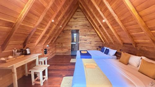 a bedroom with two beds in a wooden cabin at Nature Bliss Ella in Ella