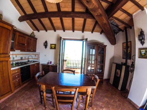 a kitchen with a table and chairs in a room at Villa Enli in Capalbio