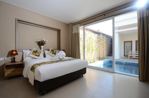 Posteľ alebo postele v izbe v ubytovaní Bali Breezz Hotel