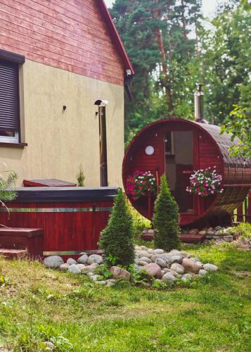 a house with a garden in front of a building at Gajówka na Roztoczu in Lubycza Królewska