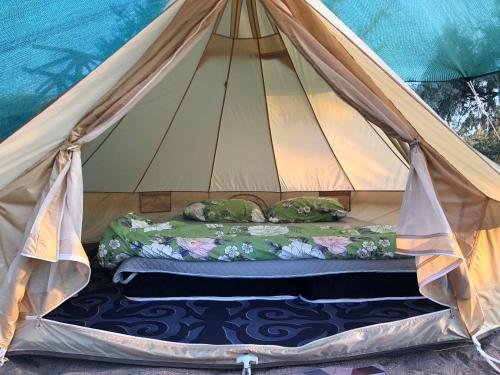 a bed in a teepee tent at Urban Monkey Summer Camp in Kaji-Say