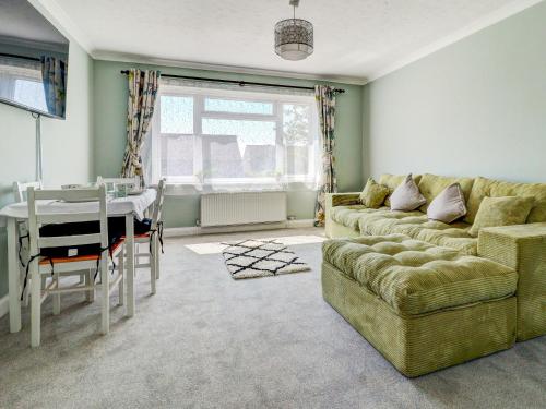 a living room with a couch and a table at Dorset Escape in Gillingham