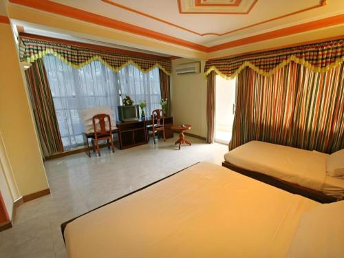 a hotel room with a bed and a television at Lucky Star Hotel in Phnom Penh