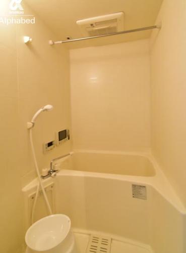 a bathroom with a toilet and a bath tub at Alphabed松山城西 in Matsuyama
