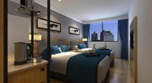 a bedroom with a large bed with blue pillows at Citytel Inn in Beijing