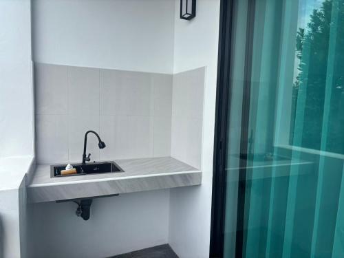 a bathroom with a sink and a shower at The Hidden Place Bangtao in Bang Tao Beach