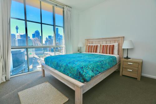 a bedroom with a bed and a large window at Goldsbrough 2 bedrooms split apartment in Sydney