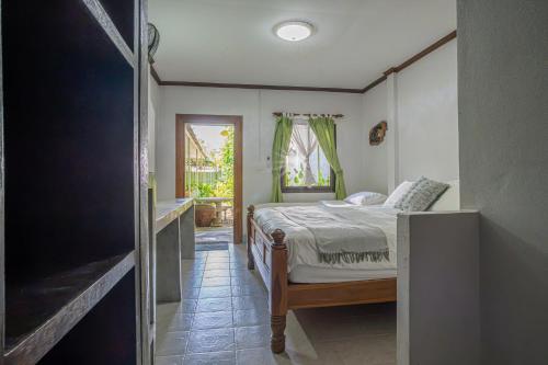 a bedroom with a bed and a bathroom at The Houme - Fisherman Village in Bophut
