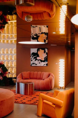 a living room with a couch and a table at Lilybeth Hotel Pratunam in Bangkok