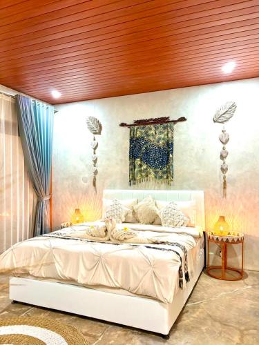 a bedroom with a large white bed in a room at Alfa Kuta in Kuta Lombok