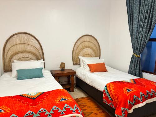 two beds sitting next to each other in a room at Casa Alento in Yzerfontein