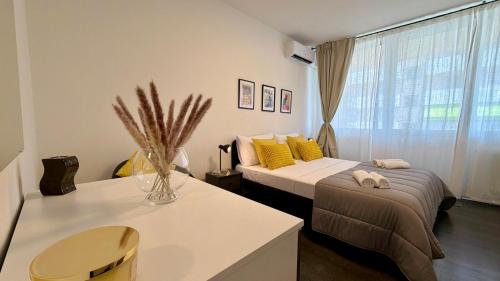 a bedroom with two beds and a window at The Yellow Corner in Pasian di Prato