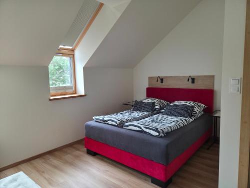 a bedroom with a bed in a attic at Via Mare in Jantar