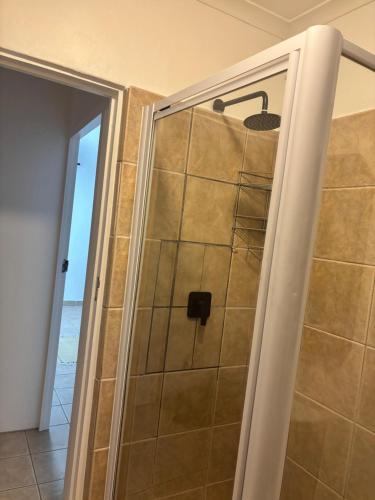 a shower with a glass door in a bathroom at Casa Alento in Yzerfontein