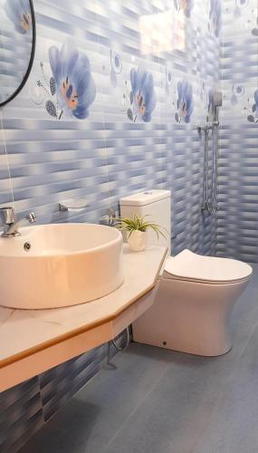 a bathroom with a sink and a toilet at Lunara Sanctuary in Induruwa