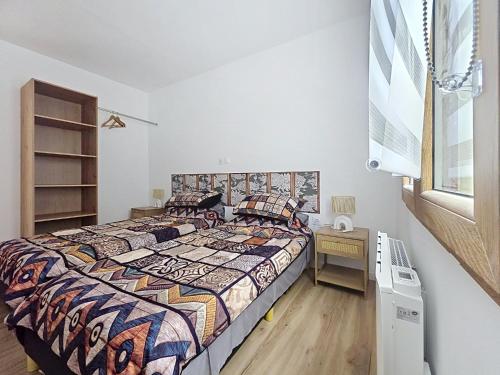 a bedroom with a bed and a desk and a window at Les Piafs du Der 2 in Joncreuil