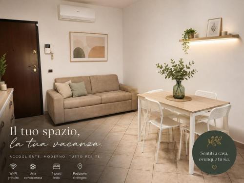 a living room with a couch and a table at Appartamento Magnolia 209 in Pomezia