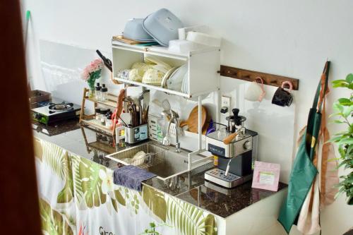 a kitchen with a counter with a coffee maker at ROSE HOUSE Cat Ba island in Cat Ba