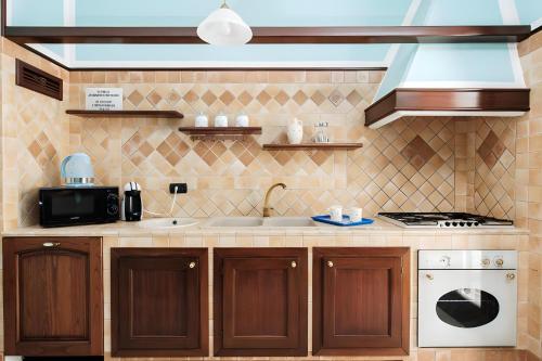 a kitchen with a sink and a stove at Villa Nicole Vista Mare in Andrano